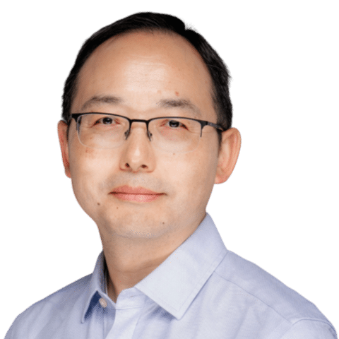 A man with short dark hair, glasses, and a light blue collared shirt is looking at the camera with a neutral expression against a plain white background. EFESO Management Consultants