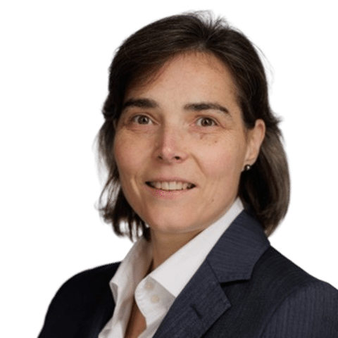 A woman with short brown hair in a dark suit jacket and white collared shirt smiles at the camera against a plain white background. EFESO Management Consultants